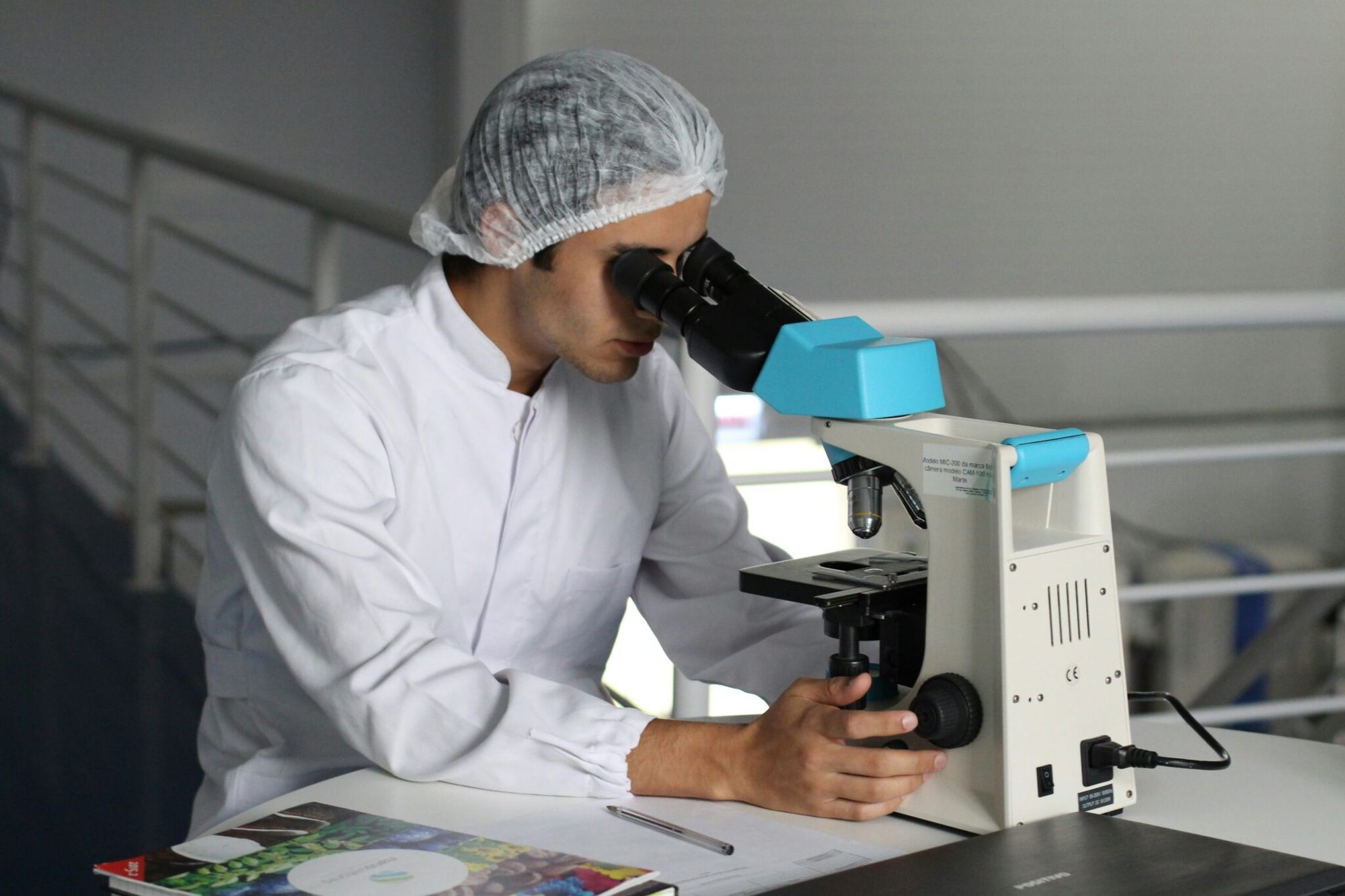 Italian laboratory researcher at microscope